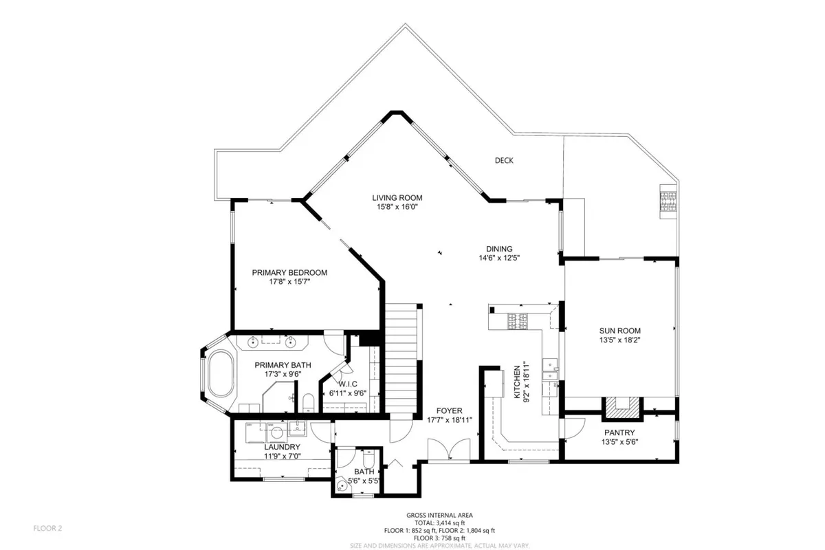 This image offers a panoramic view of the main communal gathering areas, including the living room, dining area, sun room, and visible access to the deck beyond. Multiple seating arrangements encourage group interaction, and the space is filled with natural light thanks to expansive windows and glass doors connecting to the outdoor deck.